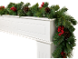 Christmas garland with pine cones and red berries on a white fireplace
