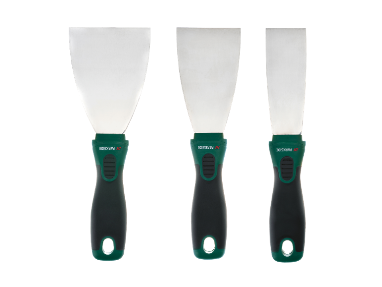 Set of three spatulas of different sizes with green and black handles.