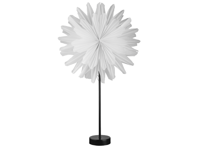 Table lamp with a white, folded paper flower-shaped lampshade on a black base.