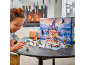 Girl playing with a castle-themed advent calendar and small figurines.
