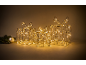 Three glowing Christmas presents with bows and a fir branch with an ornament.