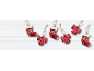 Red Christmas ornaments shaped like stockings and bows on a white wooden background.
