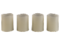 Four cream-colored LED pillar candles with wavy tops