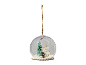 Christmas bauble with snow, tree, deer, and pine cone on a black background.