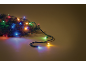 Colorful Christmas lights on pine branches, creating a festive atmosphere.