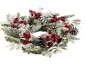 Snowy Christmas wreath with pinecones and red berries.
