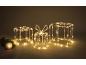 Illuminated Christmas gift boxes and an ornamental bauble with a fir branch.