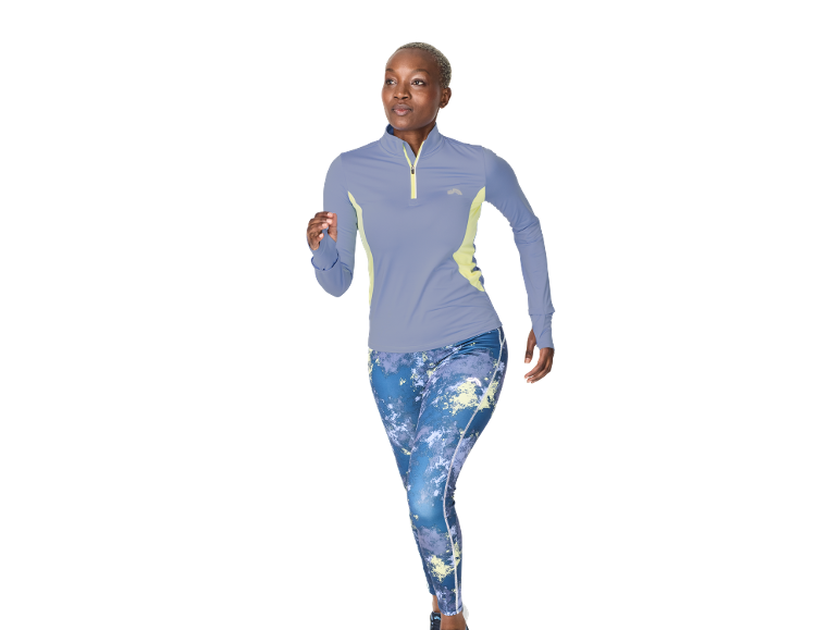 Woman in a sports top and patterned leggings, running.