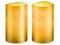 Two textured golden LED candles, lit with a warm glow.