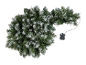 Snow-covered Christmas garland with a control box on a black background.