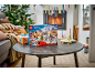 Children's advent calendar with toys on a table in a cozy festive room.