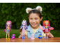 Girl playing with three dolls and three animal figures on a wooden table.