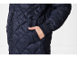 Dark blue quilted jacket with hand in pocket
