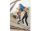 Man and woman in sportswear and sneakers running up stairs.