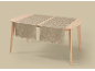 Two beige table runners with a floral pattern on a light wooden table.