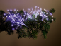 Christmas garland decoration with sparkling white LED lights on pine branches.
