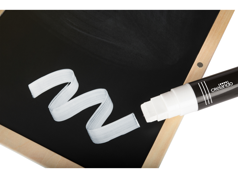 Black chalkboard with wooden frame and white marker drawing a wavy line.