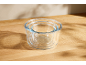 Set of three glass storage bowls on a wooden surface.