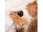 Shiny black eye on a brown and white faux fur plush toy.