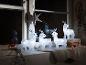 Light-up Christmas reindeer on a windowsill with a star and decorations.