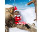 An elf sitting on a snowy log against a winter background.