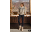 Woman in patterned beige sweater, black leggings, and light winter boots in a cozy setting.