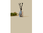 Christmas reed diffuser with black sticks, decorated with a festive house motif.