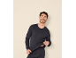 Man in dark blue long-sleeved shirt and underwear.