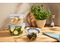 Silvercrest glass food storage container set with couscous, zucchini, and olives on a kitchen counter