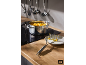 Pot of mashed vegetables on a hob, with a potato masher on a plate
