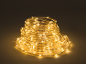 Spiral-coiled LED rope light with warm white light on a dark background.