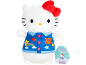 White plush toy with red bow, wearing a blue denim-style outfit with colorful patches.