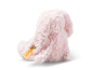 Back view of a soft pink plush bunny with a yellow ear tag