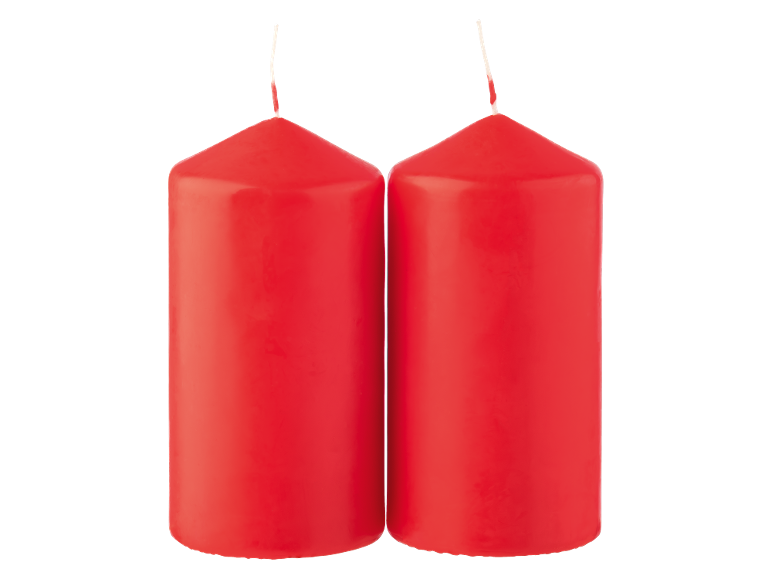 Two red pillar candles on a black background.