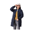 Woman in a navy quilted jacket, yellow cardigan, and grey jeans, wearing a white cap.