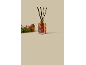 Red Christmas-themed aroma diffuser with sticks and pine decoration with berries.