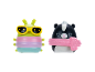 Two soft toys: a green caterpillar with sunglasses and a black and white skunk with a scarf.