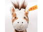 Head of a plush giraffe with a yellow tag on its ear on a white background.
