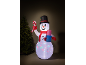 Inflatable snowman with top hat, candy cane, and gift, next to a Christmas tree.