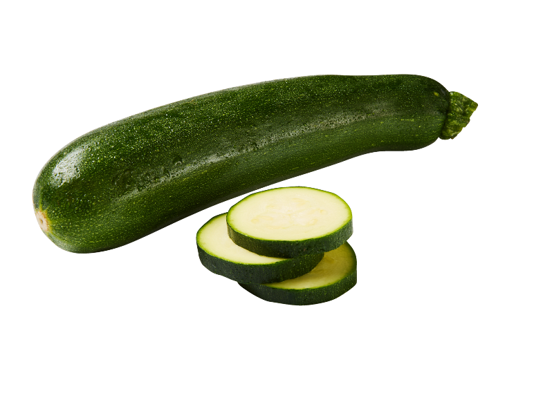 Whole green zucchini and three zucchini slices on a black background.