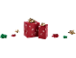 Two red Christmas gifts with snowflakes and gold bows, with additional bows.