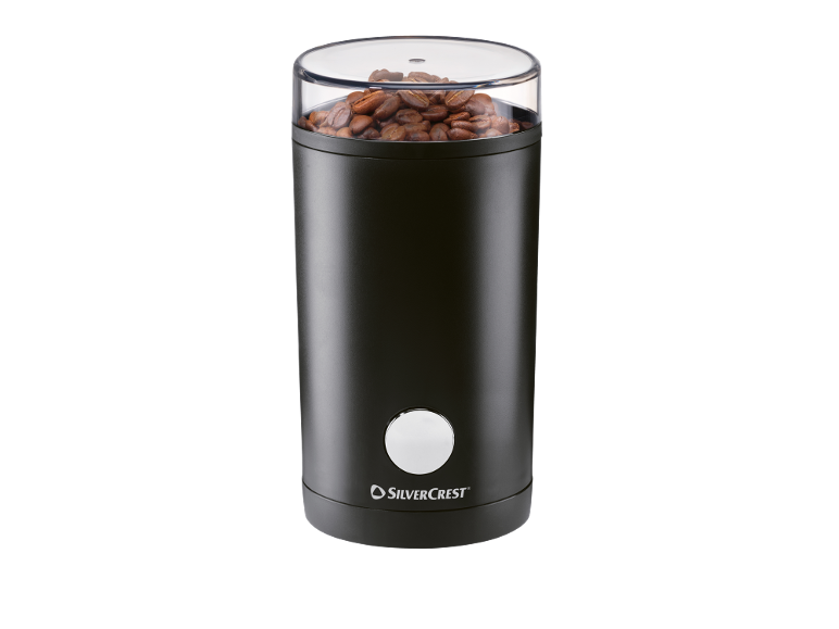 Black coffee grinder with whole coffee beans and a transparent lid.