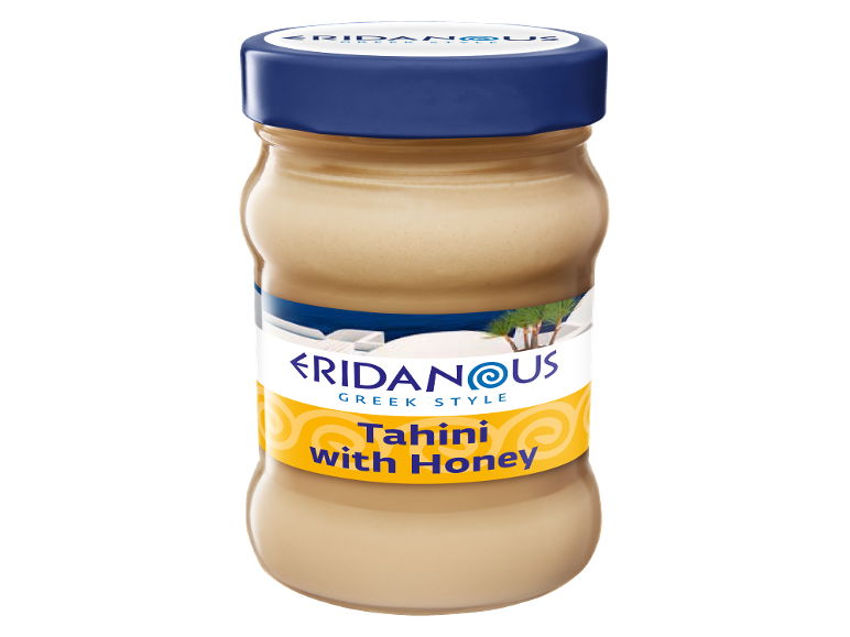 A jar of Greek style tahini with honey, featuring a blue and yellow label.