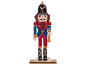 Wooden nutcracker figure in a blue and red uniform with a black hat.