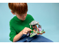 A boy plays with a building block set featuring figures and a tree.