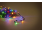Colorful Christmas lights glowing on pine branches.