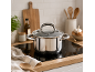Stainless steel pot on an induction hob in a modern kitchen.