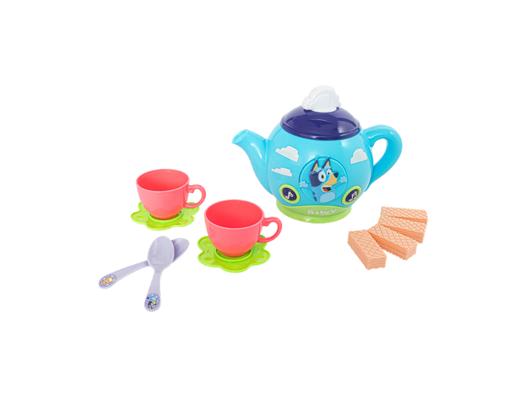 Toy tea set with a blue teapot featuring a cartoon character, pink cups, and wafers.