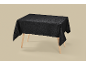 Black damask pattern tablecloth on a wooden table