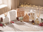 Christmas ceramic diffusers and jars shaped like houses on a wooden table.